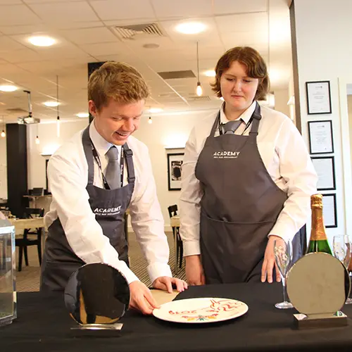 Hospitality student setting a table