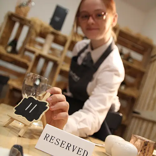 Hospitality student setting a table
