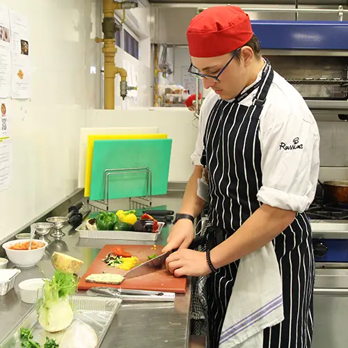 Catering student preparing food