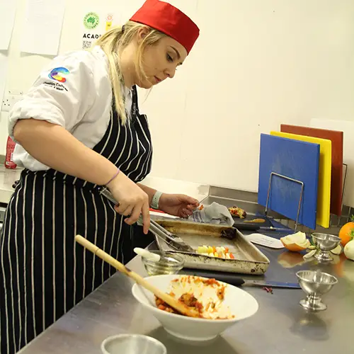 Catering student preparing food
