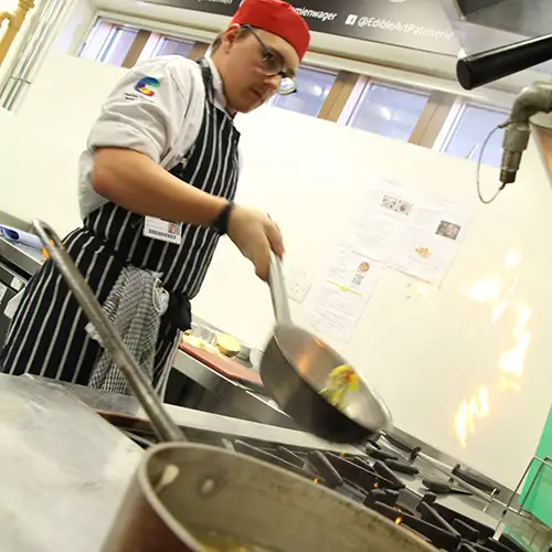 Catering student preparing food