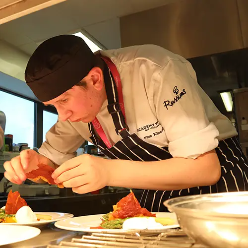 Catering student preparing food