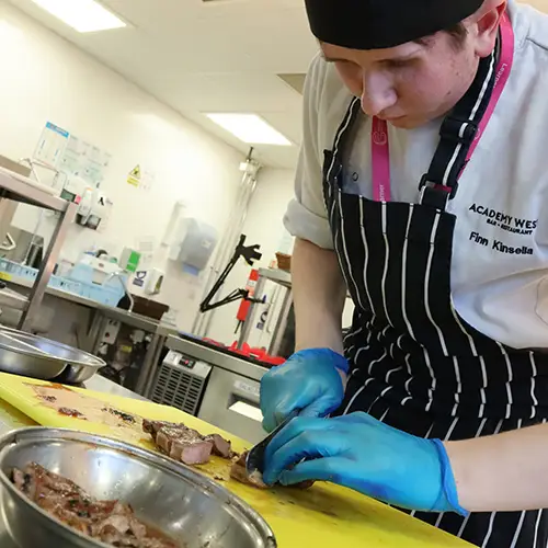 Catering student preparing food
