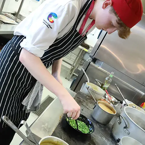 Catering student preparing food