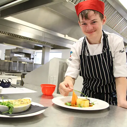 Catering student preparing food