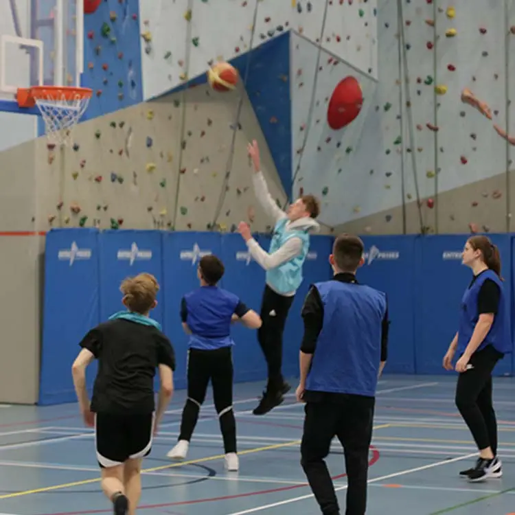 sports students on climbing wall